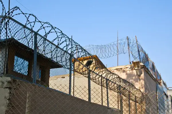 Exterior of a detention facility symbolizing prisons, jails, and immigration centers associated with institutional abuse claims.