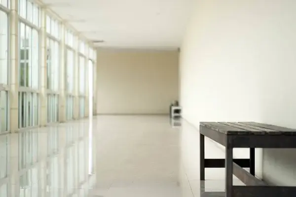 Empty walkway and institutional building corridor representing environments where abuse may have occurred and survivors seek justice.