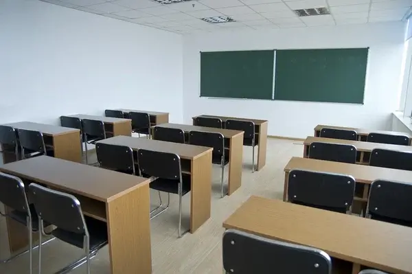 Empty classroom representing school environments and institutional settings where survivors of abuse may have endured harm.